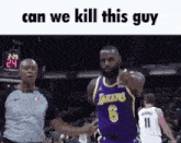 a basketball player in a purple jersey is pointing at a referee during a game .