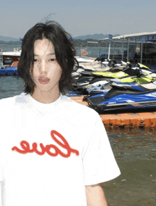 a man wearing a white t-shirt with the word evol on it
