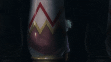 a close up of a person 's face with a red and white item in the background
