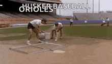 a group of men are working on a baseball field in a baseball stadium .