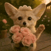 a fox wearing a tiara is holding a bouquet of pink roses .
