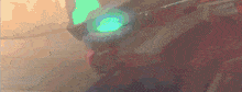 a close up of a person 's head with a green light on it .