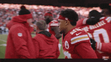 a group of football players are huddled together with one wearing the number 0