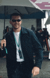 a man wearing sunglasses and a lanyard with a tag that says ' alonso ' on it