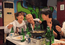 a group of people sitting at a table with bottles of terra beer on it