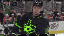 a hockey player wearing a green jersey with the number 5 on it