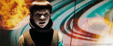 a young boy stands in front of a colorful background with the words acting-captains-log.tumblr.com at the bottom