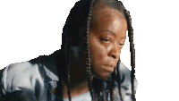 a woman with braids on her head looks down at something