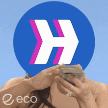 a woman is holding a bunch of money in front of a large h logo