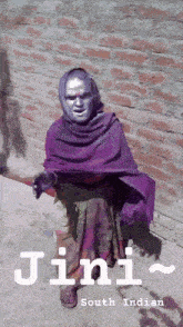 a woman with silver paint on her face and the word jini south indian