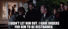 a man in a sheriff 's uniform talks to a man in a military uniform