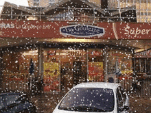 a car is parked in front of a store called la goulette
