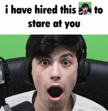 a man wearing headphones with his mouth open and the words " i have hired this to stare at you " below him