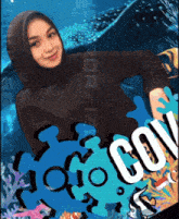 a woman in a black hijab stands in front of a whale shark and the word cov on a blue background
