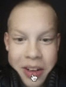 a close up of a boy 's face with a crown in his mouth and headphones .