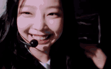 a close up of a woman 's face with a microphone in her mouth