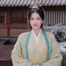 a woman wearing a yellow and blue dress and a crown on her head