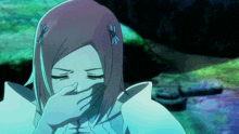 a girl with flowers in her hair covering her mouth with her hand