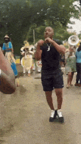 a man in a black shirt stands in front of a band