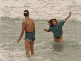 a man and a woman are in the ocean