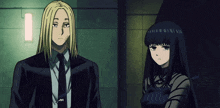 a man in a suit and tie is standing next to a woman in a black dress
