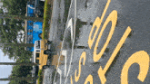a yellow van is parked in a parking lot with a yellow sign that says ' abc '