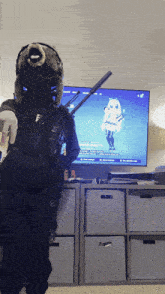 a person standing in front of a tv with a game on
