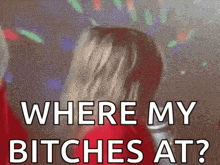 a woman is dancing at a party and the words where my bitches at are on the screen .