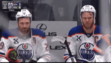 two hockey players with the word oilers on their shirts