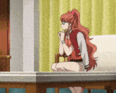 a girl with red hair and glasses sits on a couch