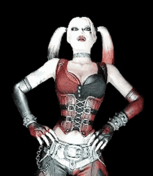 a woman in a harley quinn costume is standing with her hands on her hips in a dark room .