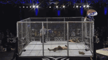 a wrestler is jumping over a chain link fence in a ring that says nct