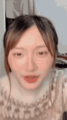 a close up of a woman 's face with her eyes closed and her mouth open .