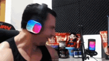 a man wearing headphones is sitting in front of a microphone and a box that says 80 % on it