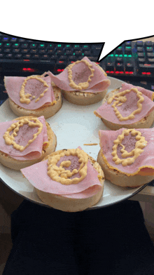 a white plate topped with sandwiches with ham and cheese