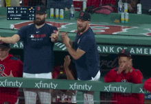 a baseball game is being played in a dugout with xfinity banners