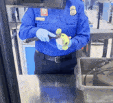 a security guard is holding a stuffed animal in his hand
