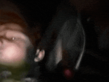 a blurry photo of a person 's face in the dark