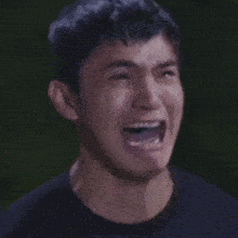 a close up of a man 's face with his mouth open