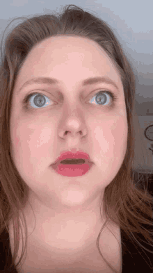 a close up of a woman 's face with red lips