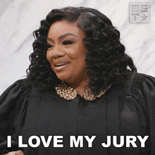 a woman in a judge 's gown is smiling and says i love my jury
