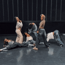 a group of female dancers are doing a routine on a black floor
