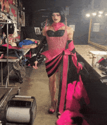 a drag queen in a pink and black dress