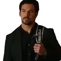 a man in a suit is holding a backpack that says ' dd ' on it