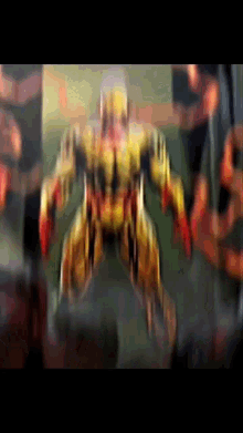 a blurred image of a robot with red arms and legs .