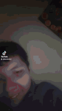 a phone screen shows a tiktok video of a woman 's face