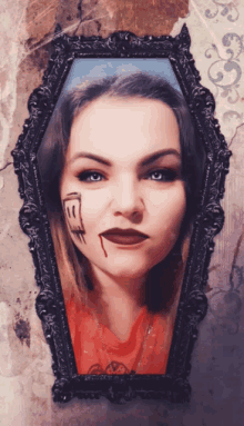 a picture of a woman in a coffin frame with blood on her face