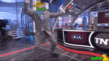 a man in a suit is dancing in front of a kia logo