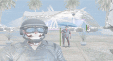 a man wearing a skull mask and goggles is standing in front of a building