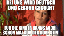 a woman is sitting in front of a plant with a caption that says `` bei uns wird deutsch und gesund gekocht ``